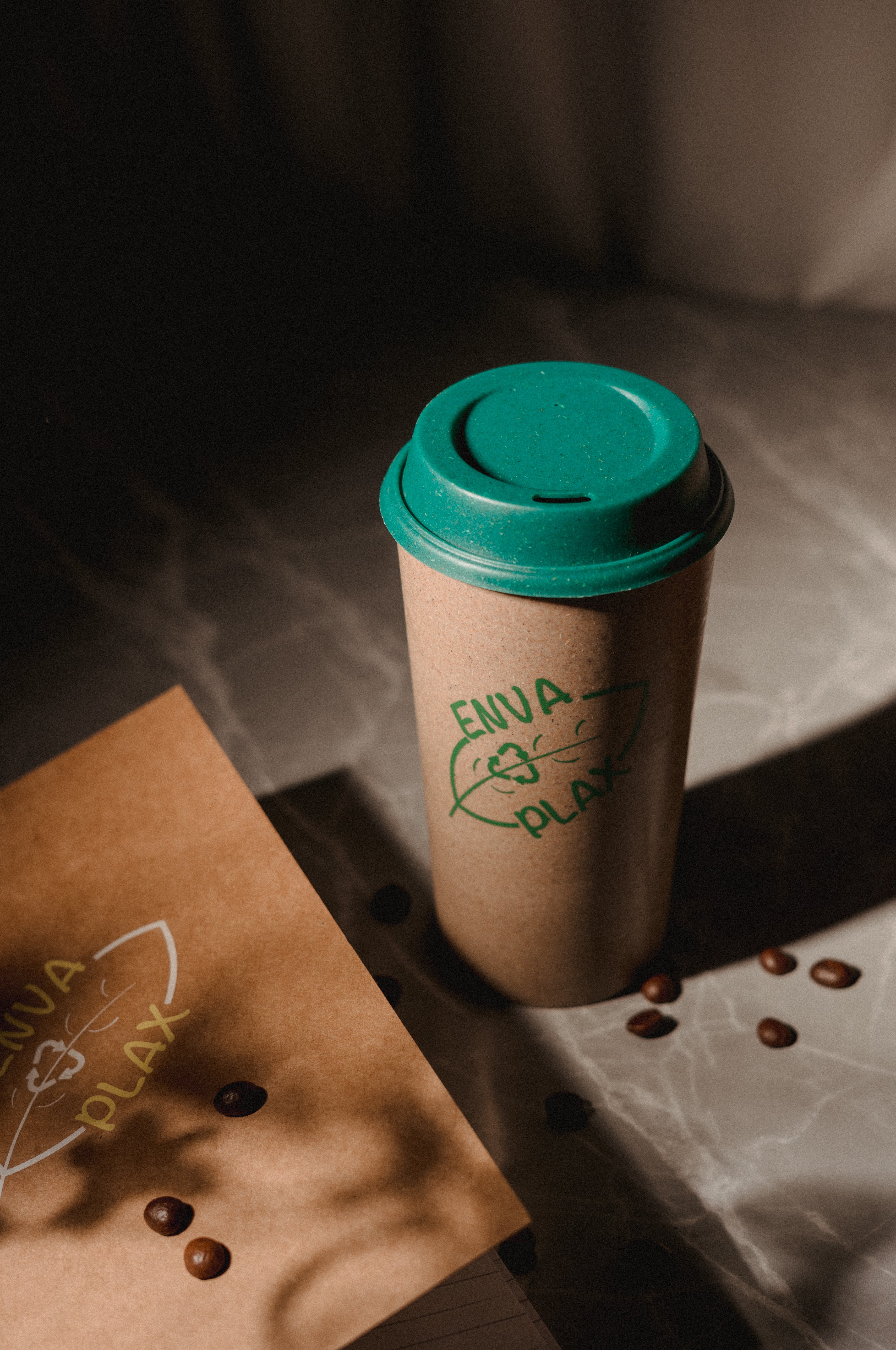 Eco-conscious workspace featuring a brown cover diary and recycled coffee mug