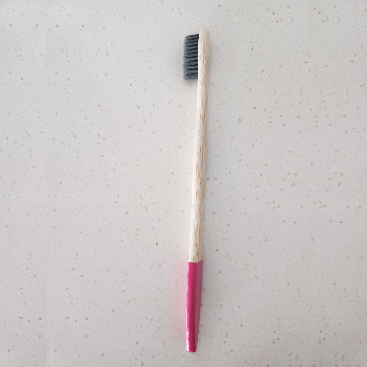 Artistically designed bamboo toothbrush with dipped handle feature, perfect for modern bathrooms